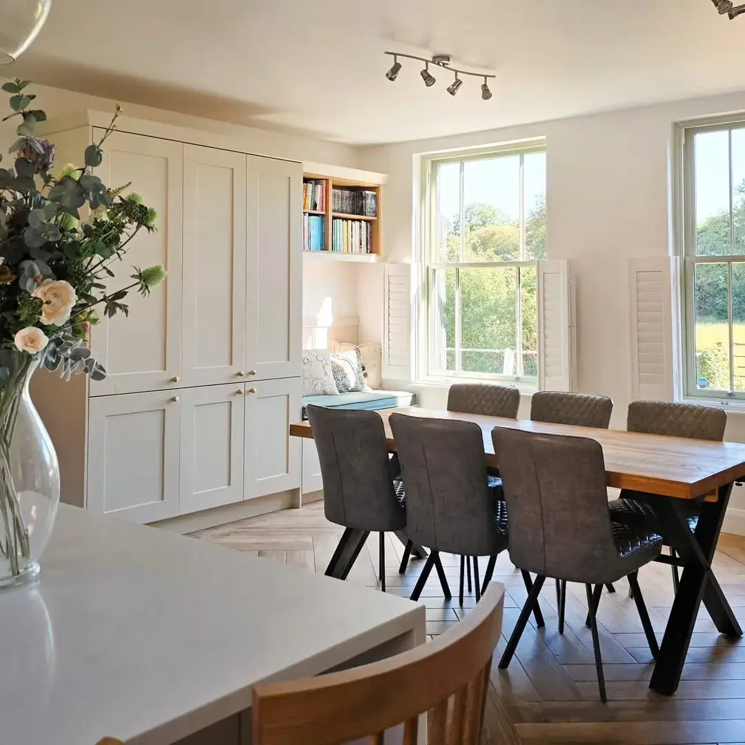 Cafe style shutters with panels folded back in a beautiful white classic kitchen