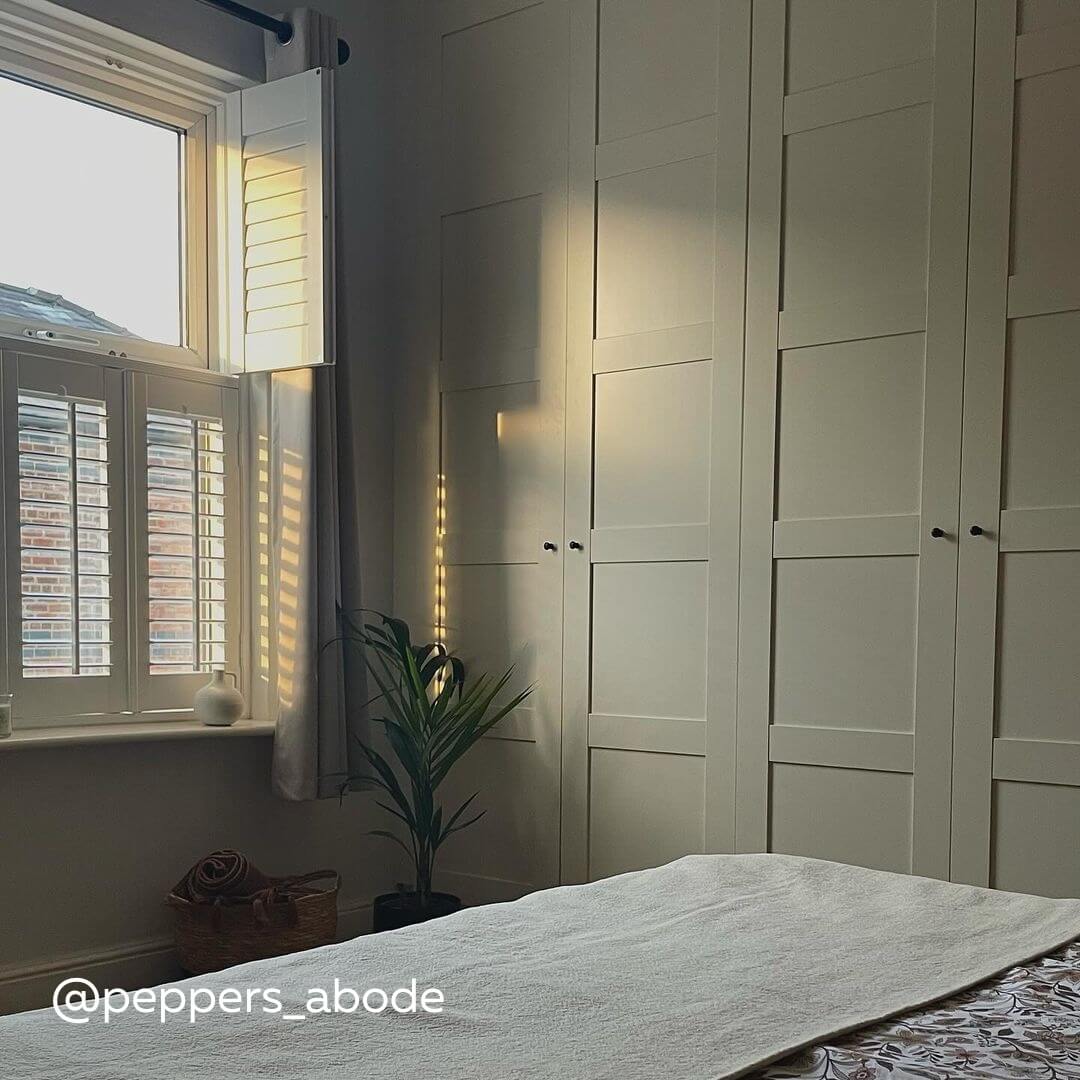 White Tier on Tier Shutters in a modern bedroom with plant