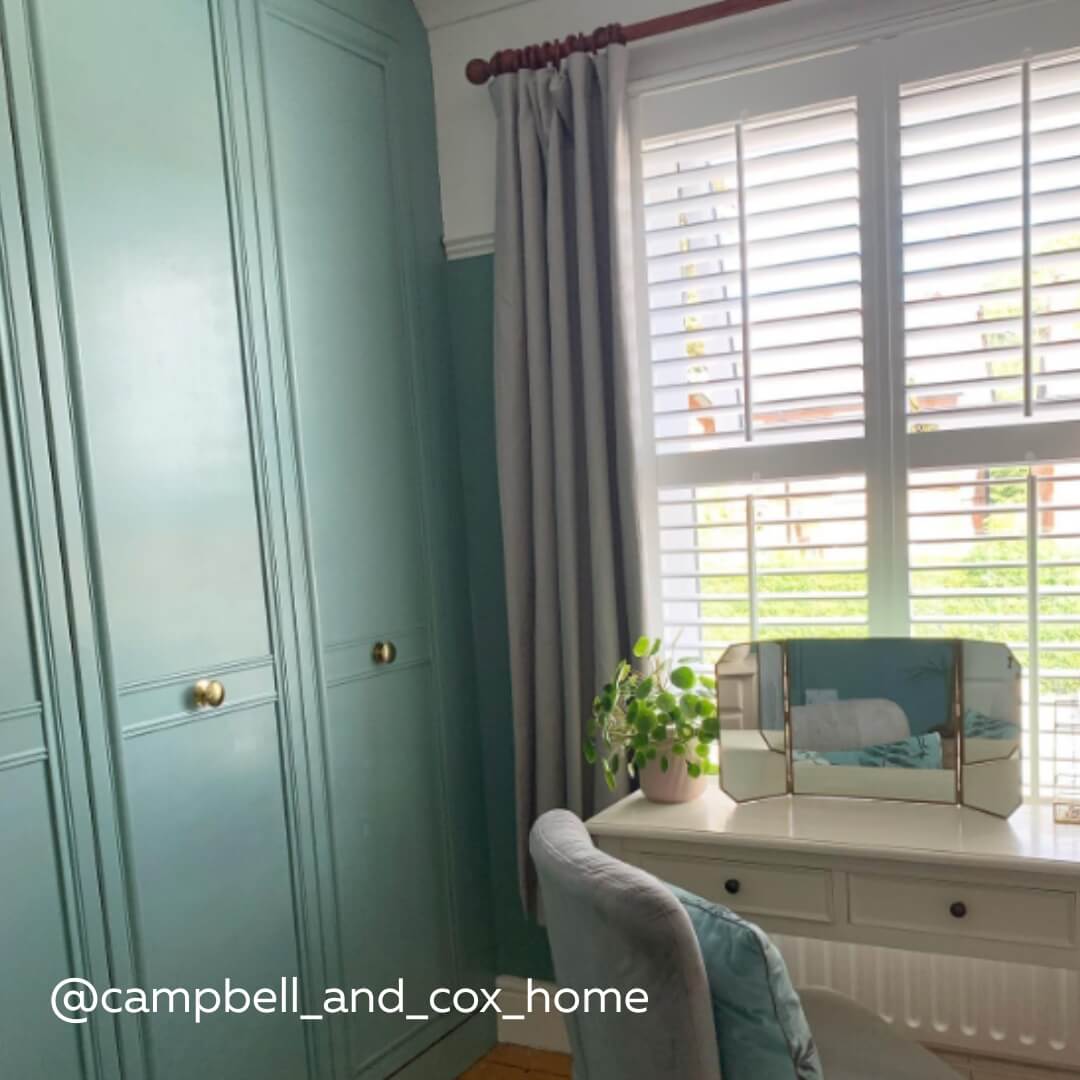 White Full Height Shutters with midrail in a classic styled bedroom with dressing table and pilea