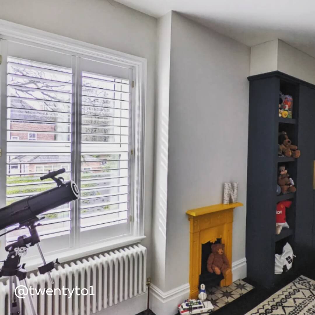 White Full Height Shutters in a young person's bedroom with yellow fireplace and telescope