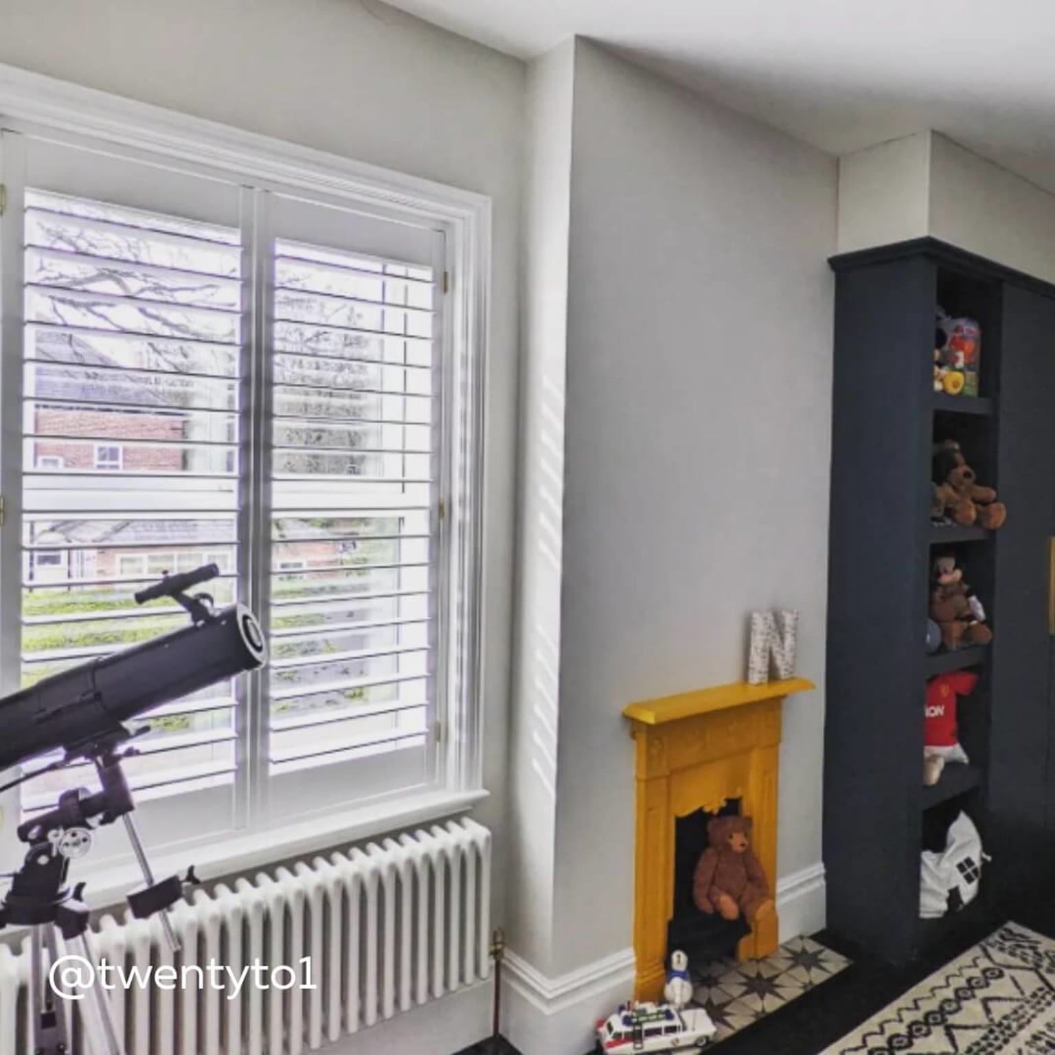White Full Height Shutters in a young person's bedroom with yellow fireplace and telescope