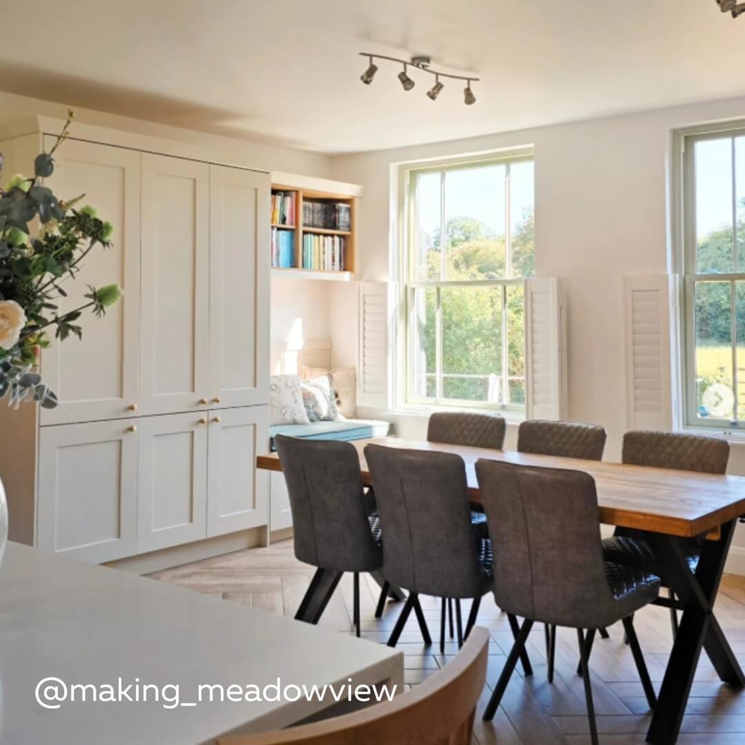 White Cafe Style Shutters with wooden dining table and cosy reading nook