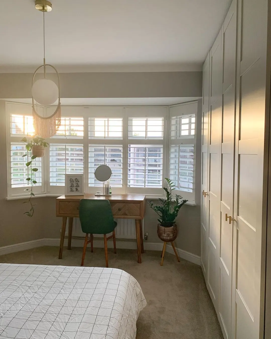 White Full Height Shutters with midrail in a modern bedroom 