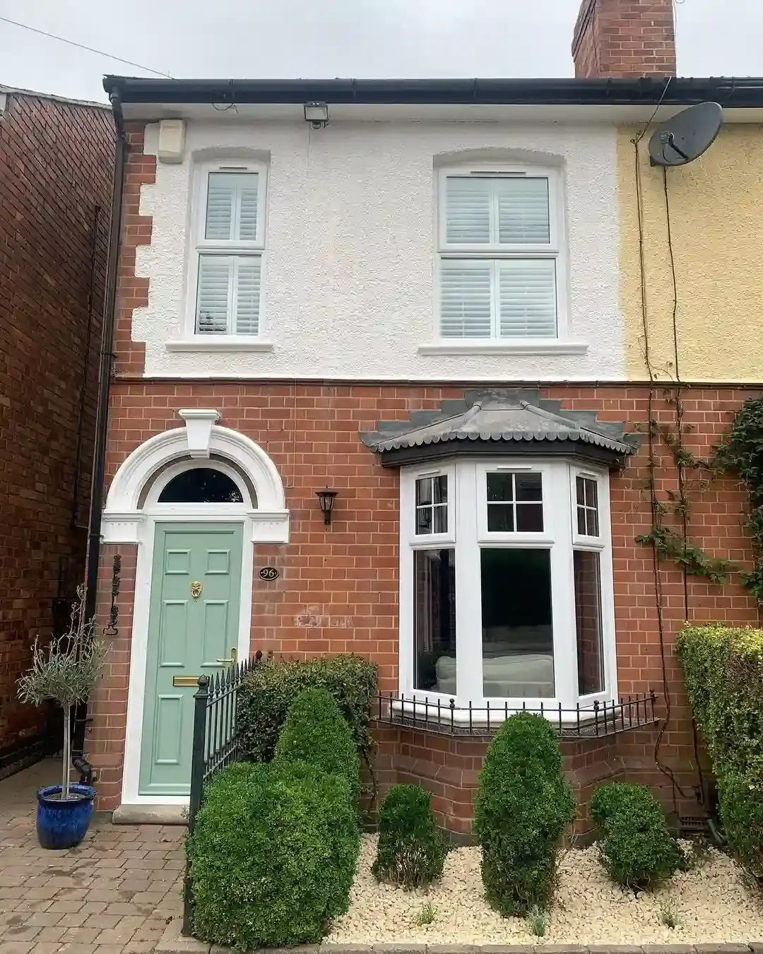 White full height plantation shutters on the exterior of a Victorian house