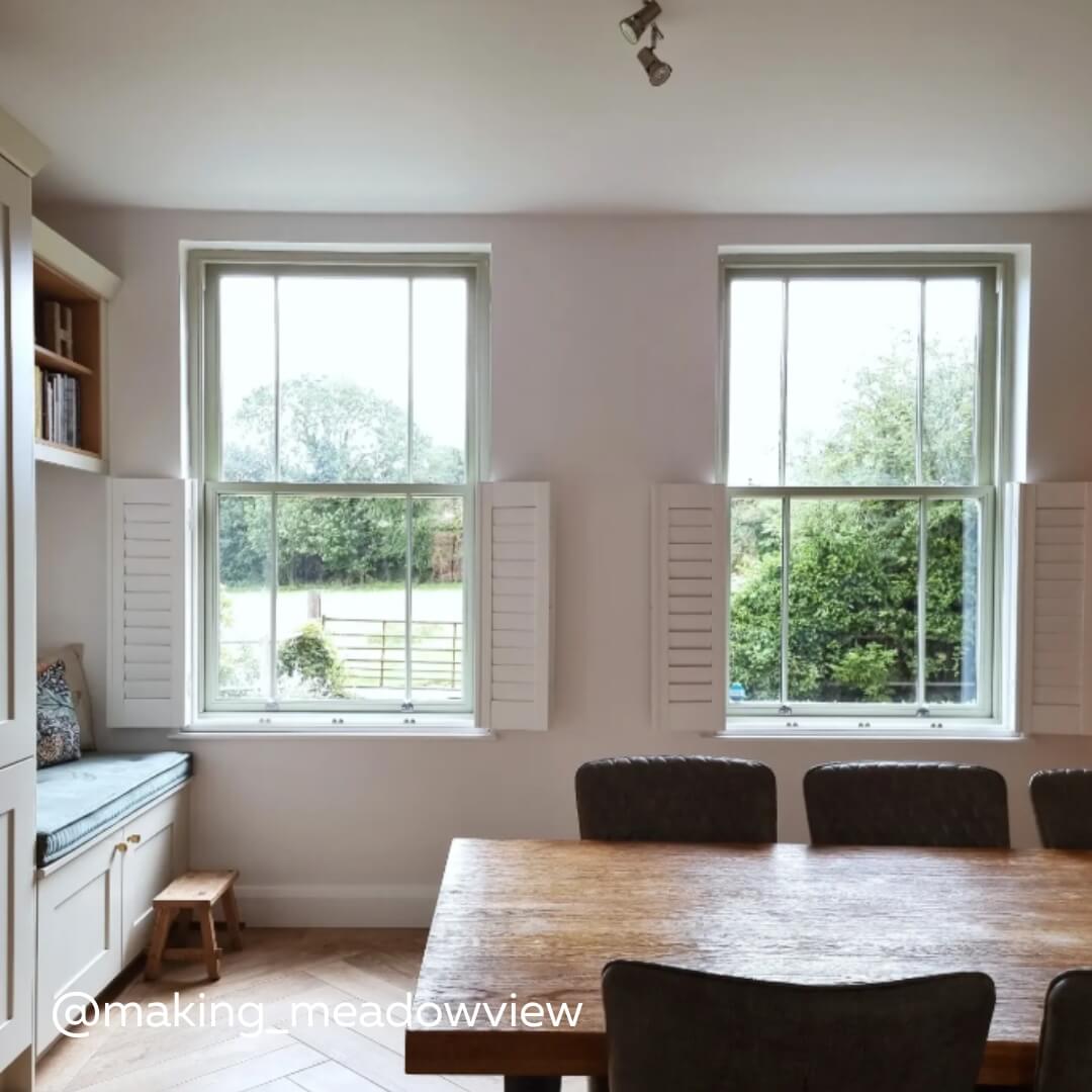 White Cafe style shutters with hidden tilt rod and narrow panels in a cosy rustic home