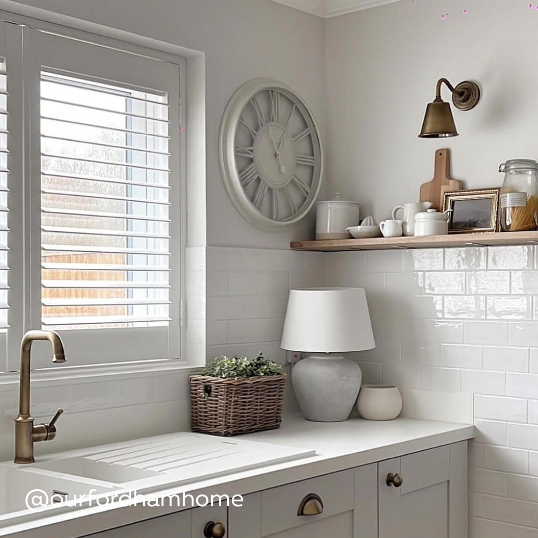 White Full Height Shutters above a modern kitchen sink in soft white and grey kitchen