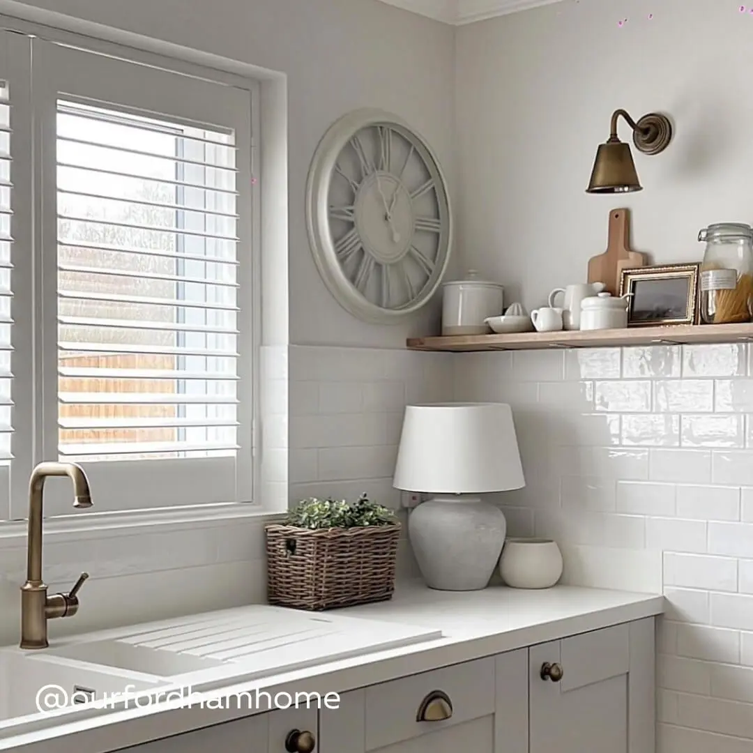 White Full Height Shutters above a modern kitchen sink in soft white and grey kitchen