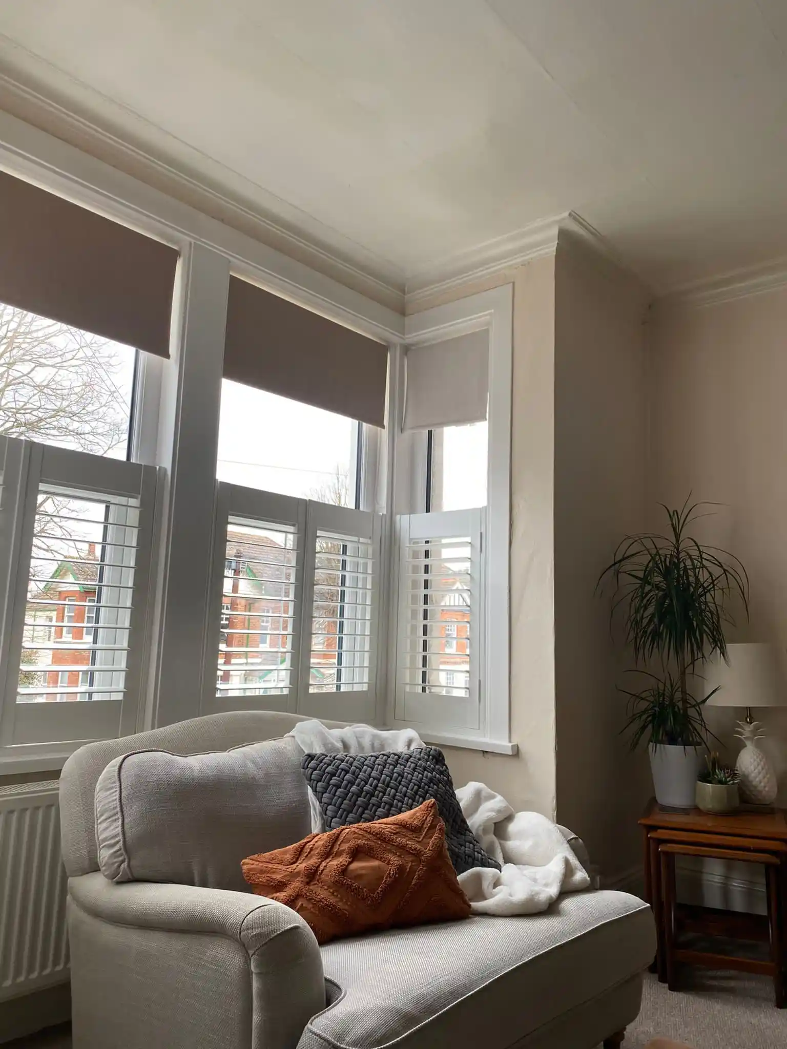 White cafe style shutters on box bay living room window