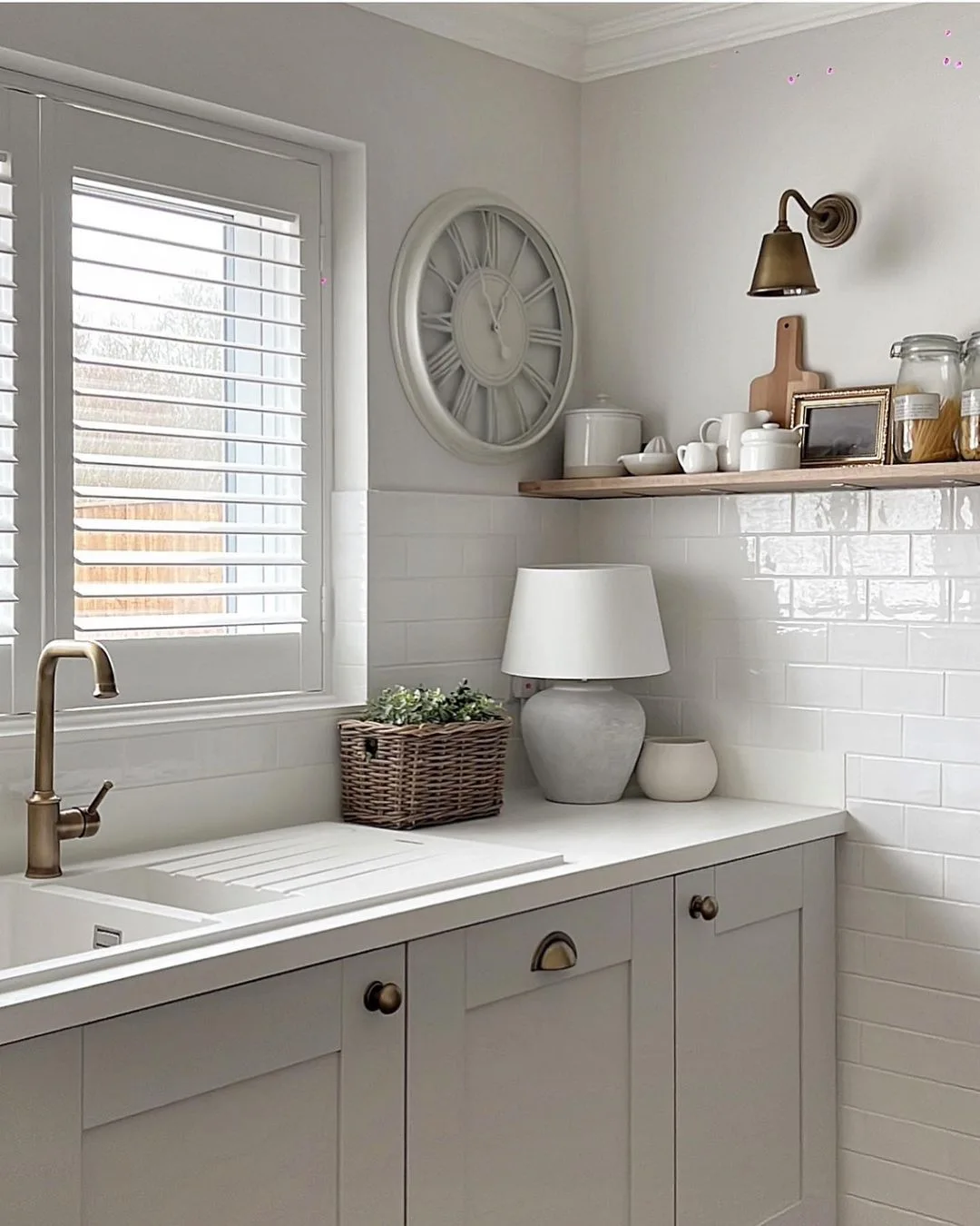 White Full Height Shutters above a modern kitchen sink in soft white and grey kitchen